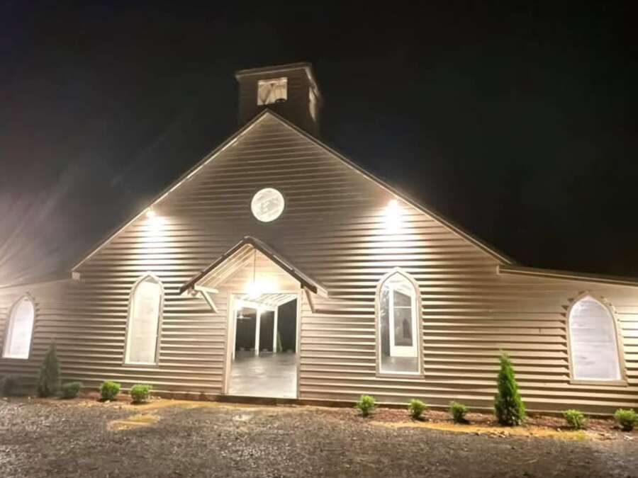 The white chapel lit up against the dark.