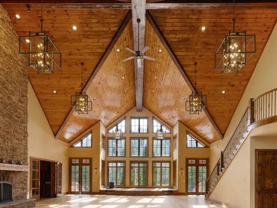 The lodge great room, with a vaulted timber ceiling and tall windows.